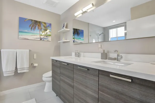 a bathroom with a double vanity sink and a mirror