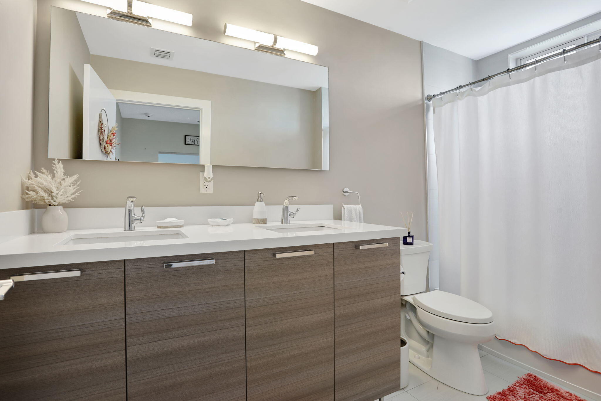 1900 Southeast 2nd Street, Unit 501 Deerfield Beach, FL 33441 - Photo 27 of 41 a bathroom with a toilet sink and mirror