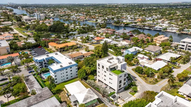 an aerial view of residential houses with outdoor space