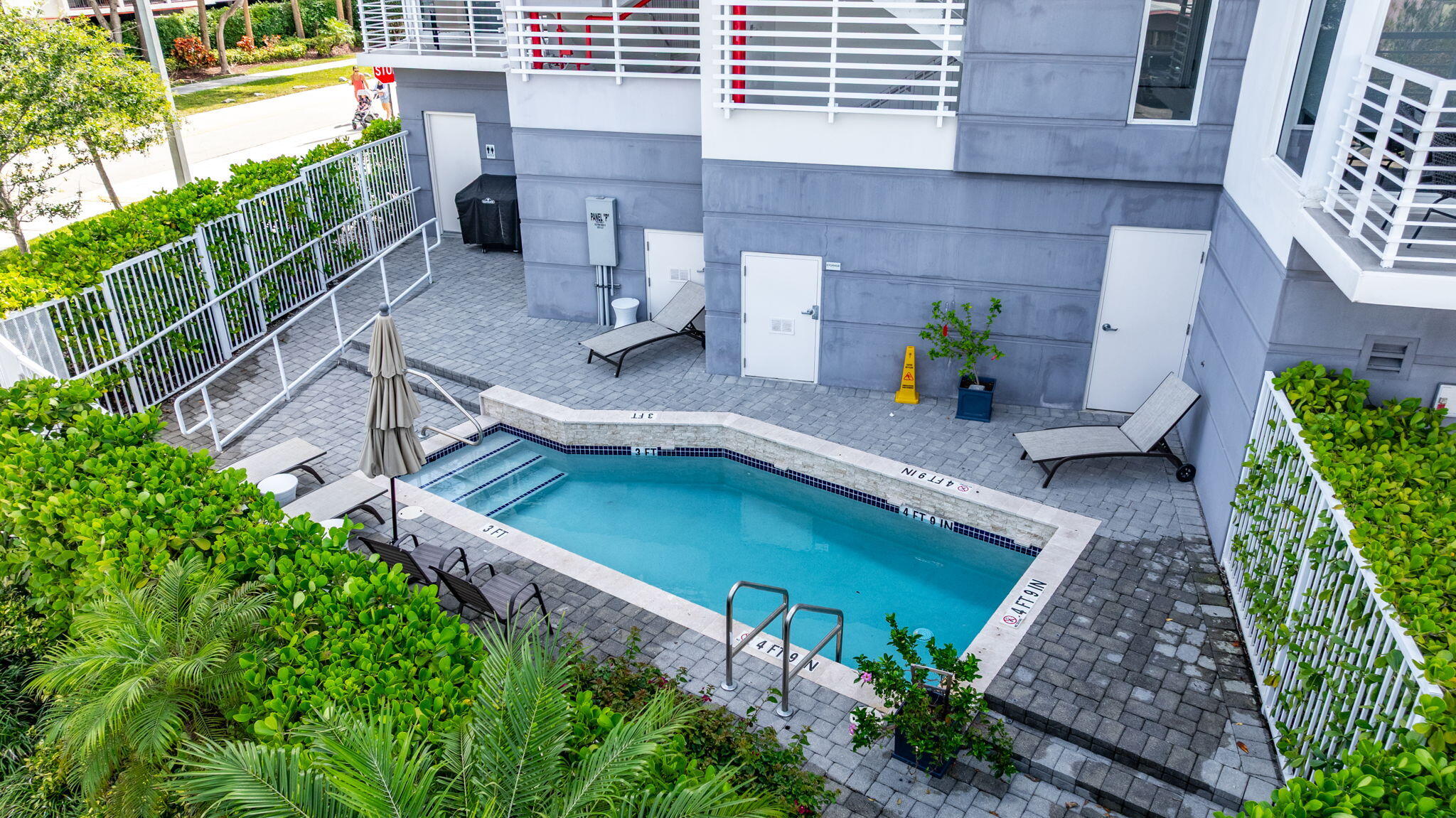 1900 Southeast 2nd Street, Unit 501 Deerfield Beach, FL 33441 - Photo 40 of 41 a view of a backyard with plants and a patio