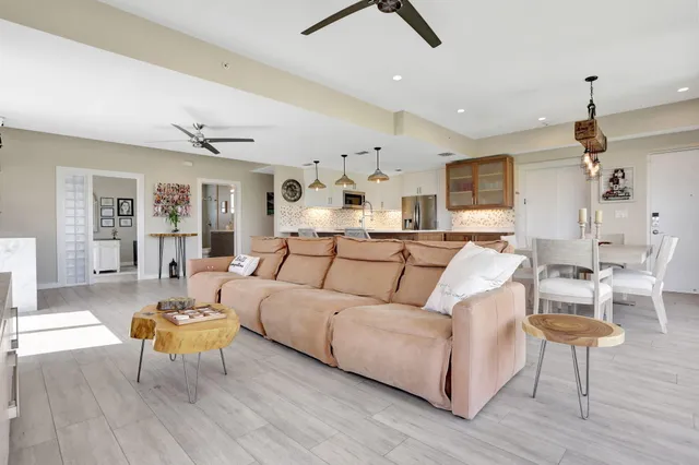 a living room with furniture and a wooden floor