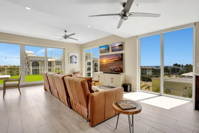 a living room with furniture and a floor to ceiling window