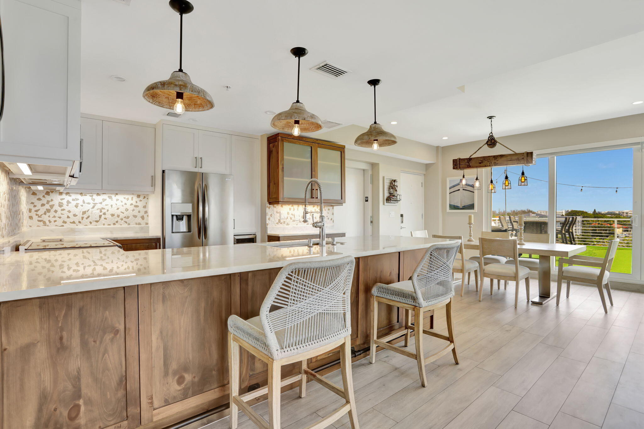 1900 Southeast 2nd Street, Unit 501 Deerfield Beach, FL 33441 - Photo 8 of 41 a view of a dining room and livingroom with furniture wooden floor a chandelier