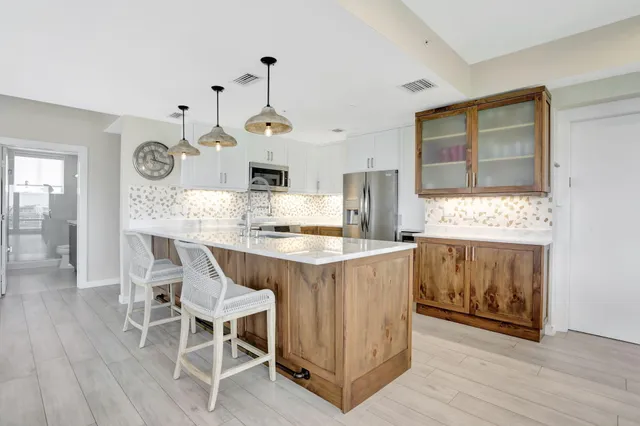 a view of a kitchen with a table and chairs