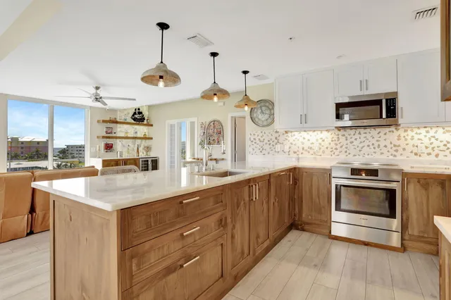 a kitchen with stainless steel appliances granite countertop a stove and cabinets