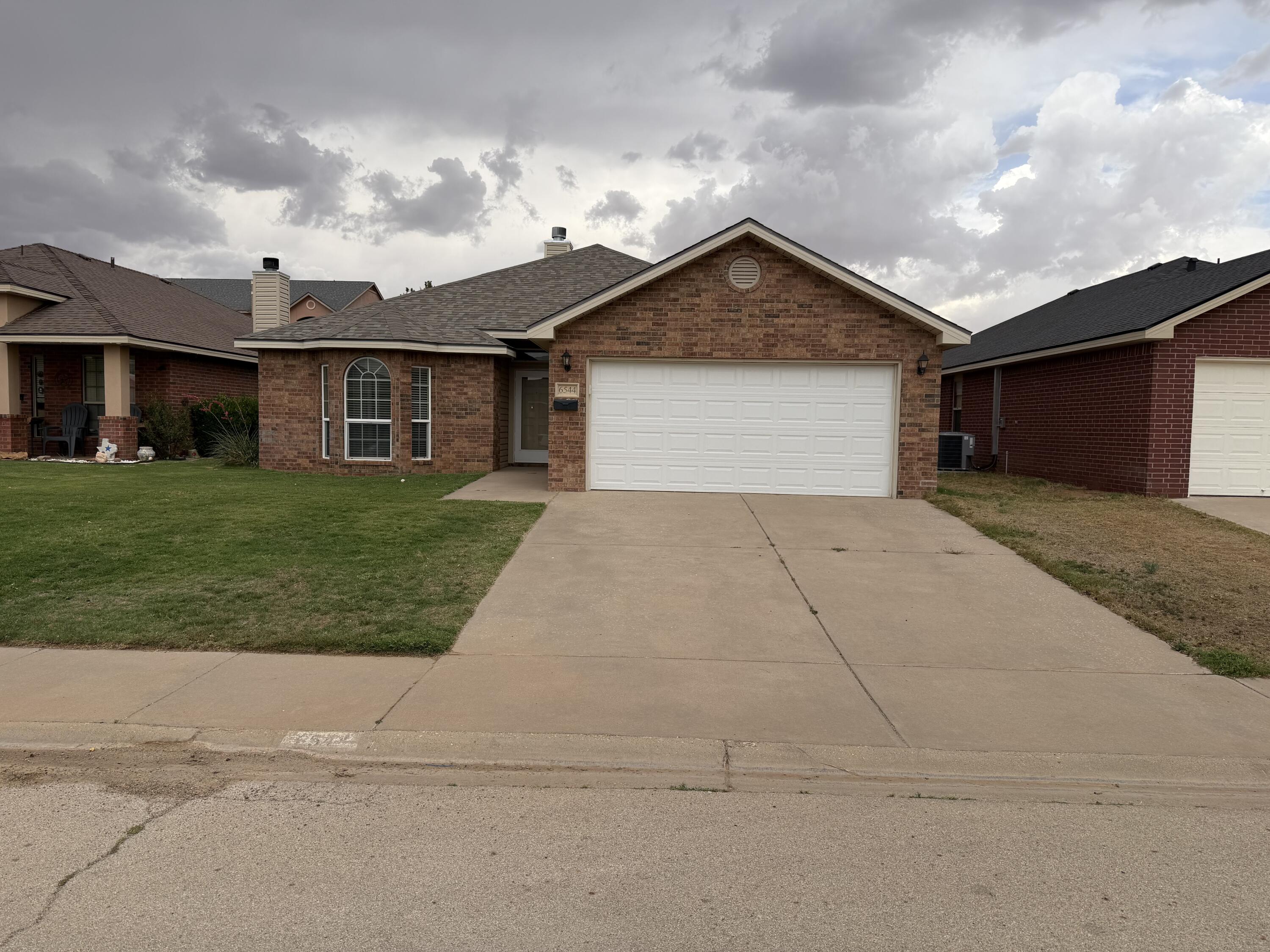 6544 84th Street Lubbock, TX 79424 - Photo 1 of 29 a front view of house with yard and green space