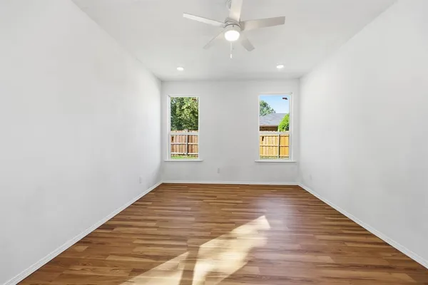 wooden floor in an empty room with a window