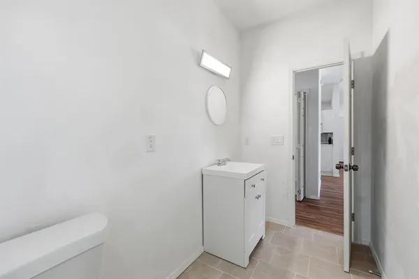 a bathroom with a toilet sink and vanity