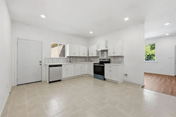 a large kitchen with stainless steel appliances cabinets and a sink