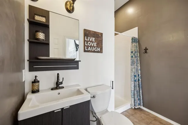 a bathroom with a sink toilet and mirror