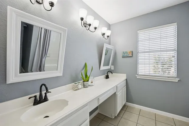 a bathroom with a double vanity sink and a mirror