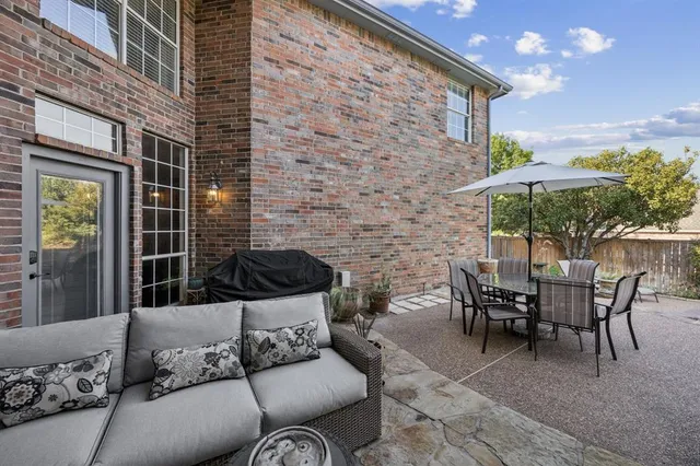 a balcony with furniture and a potted plant