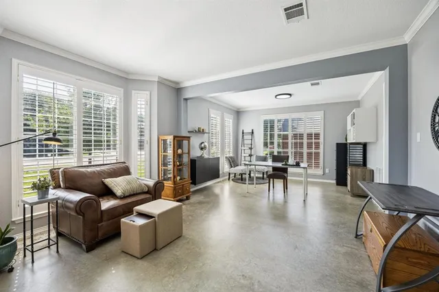 a living room with fireplace furniture and a large window