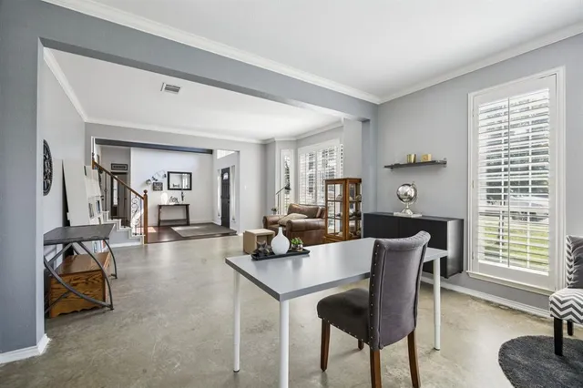a view of a dining room with furniture and a window