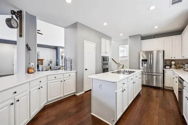 a kitchen with white cabinets and white appliances