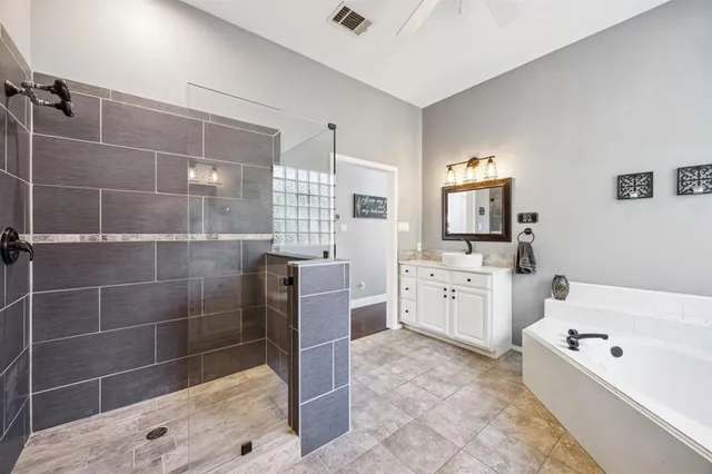 a bathroom with a bathtub sink and mirror