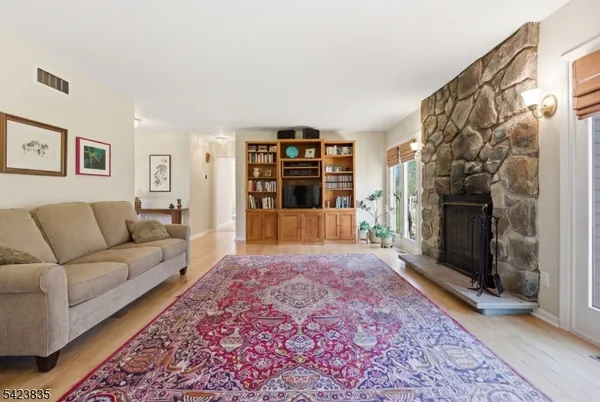 a kitchen with a dining table chairs sink and white cabinets