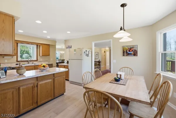 a kitchen with stainless steel appliances granite countertop a sink refrigerator and cabinets