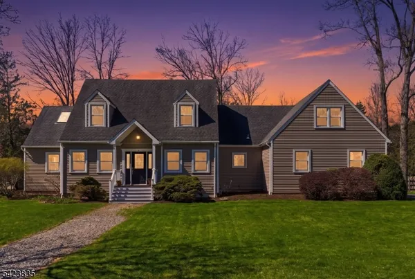 a front view of a house with a garden and yard