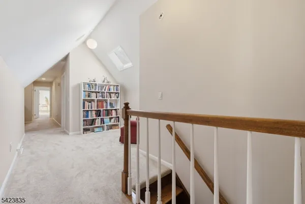 a living room with a book shelf and a book shelf