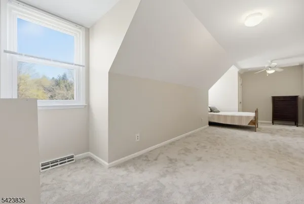 a view of a livingroom with furniture and a window