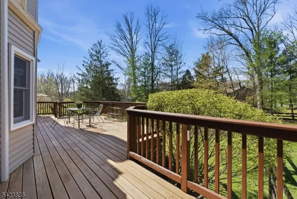 a front view of a house with garden and trees