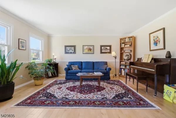 a living room with furniture a piano and a table