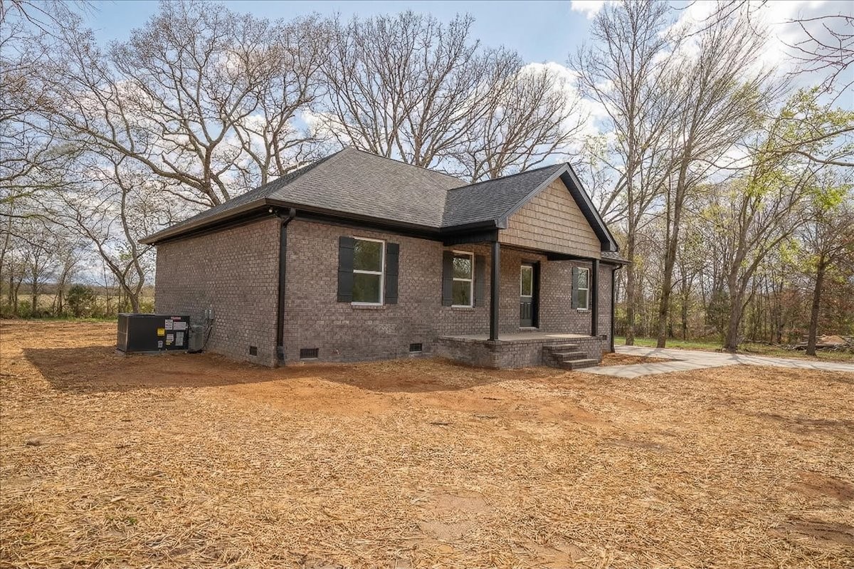 3987 Buffalo Road Summertown, TN 38483 - Photo 3 of 26 a house that has a tree in front of it