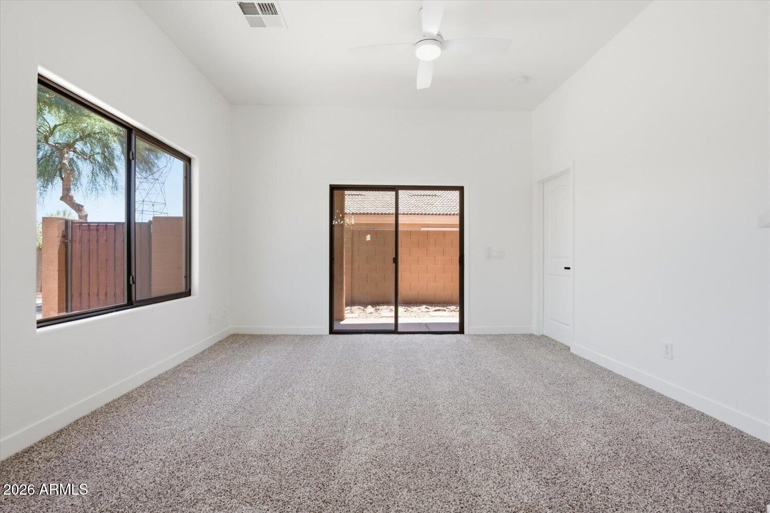 2565 South Signal Butte Road, Unit 23 Mesa, AZ 85209 - Photo 5 of 29 an empty room with windows and closet