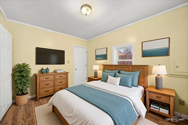 a bedroom with a bed and a flat screen tv