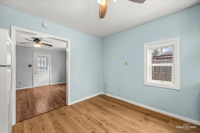 a view of empty room with wooden floor