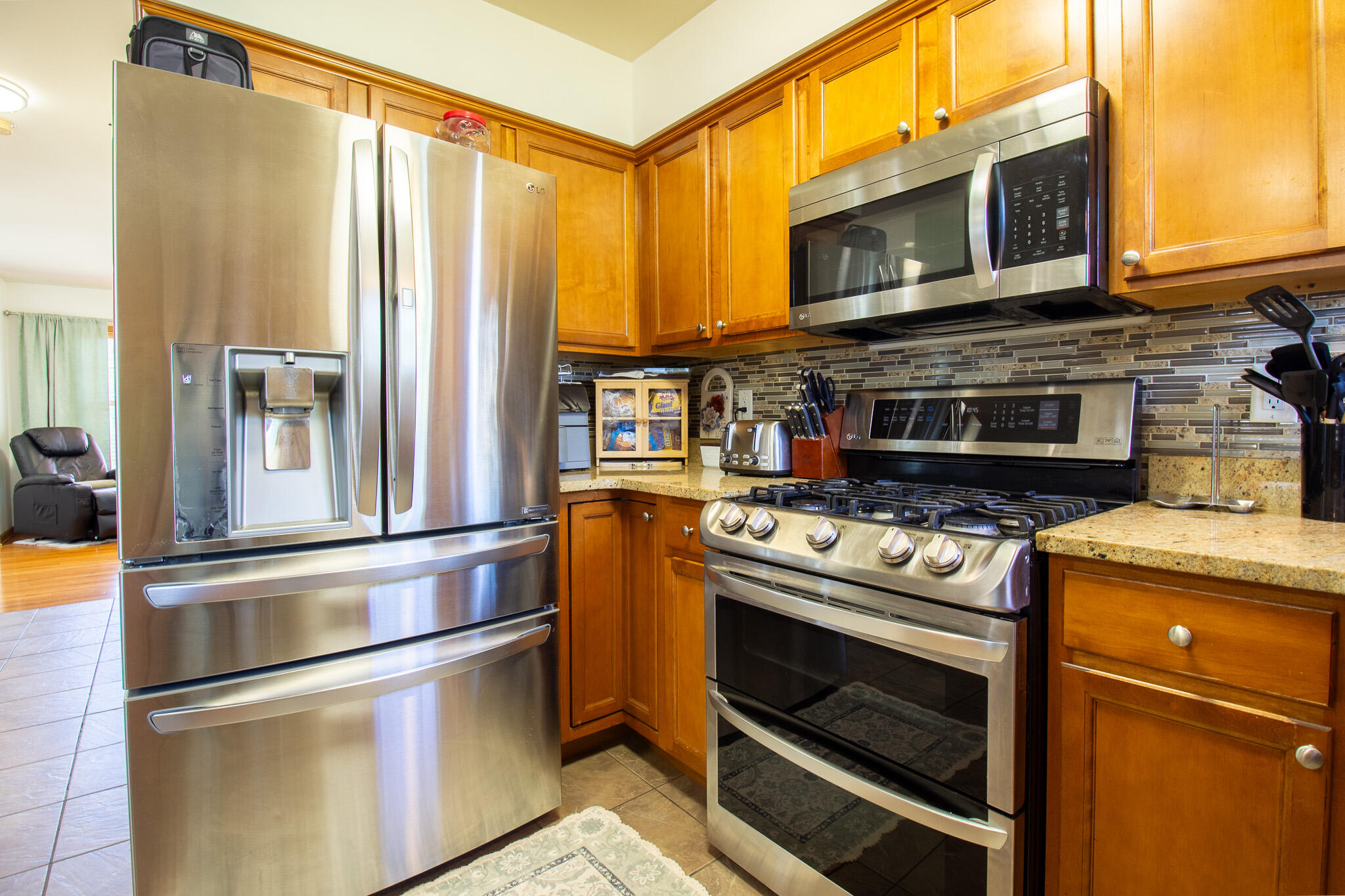 2550 Honelee Court Valparaiso, IN 46385 - Photo 14 of 37 a kitchen with stainless steel appliances granite countertop a stove a microwave and a refrigerator