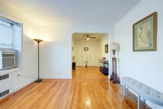 a view of a room with wooden floor and furniture