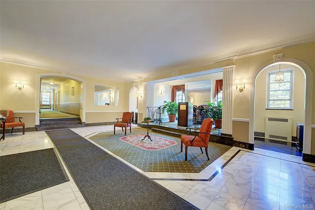 a living room with furniture a table and large windows