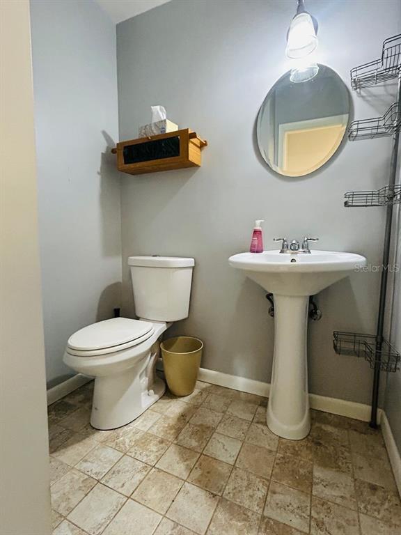 608 Southwest 80th Boulevard Gainesville, FL 32607 - Photo 11 of 25 a bathroom with a toilet sink and mirror