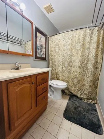 a bathroom with a sink toilet and a mirror