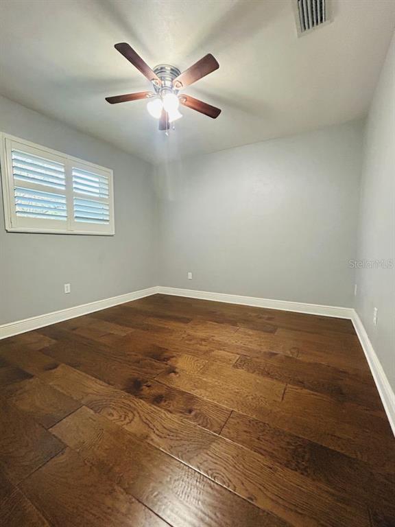 608 Southwest 80th Boulevard Gainesville, FL 32607 - Photo 23 of 25 an empty room with wooden floor and windows