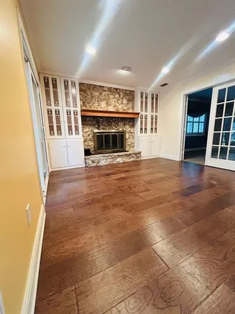 a view of an empty room with window and fire place