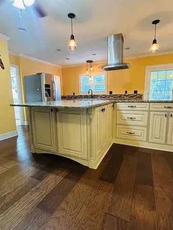 a kitchen with stainless steel appliances granite countertop a sink a stove and cabinets