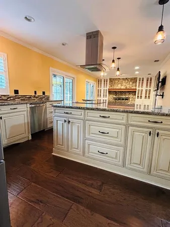 a kitchen with granite countertop a sink cabinets stainless steel appliances and a counter space