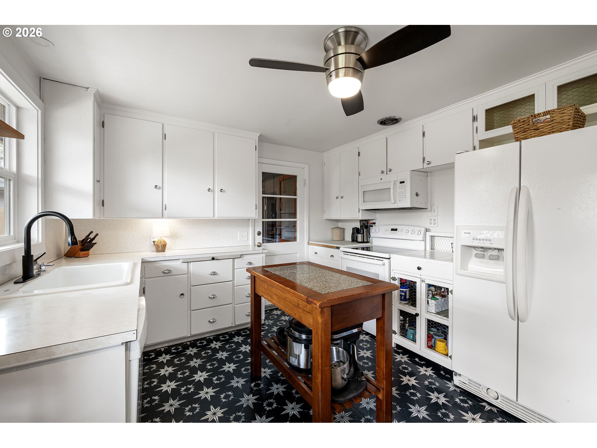 765 Louis Street Eugene, OR 97402 - Photo 17 of 45 a kitchen with stainless steel appliances a stove a sink a refrigerator and white cabinets