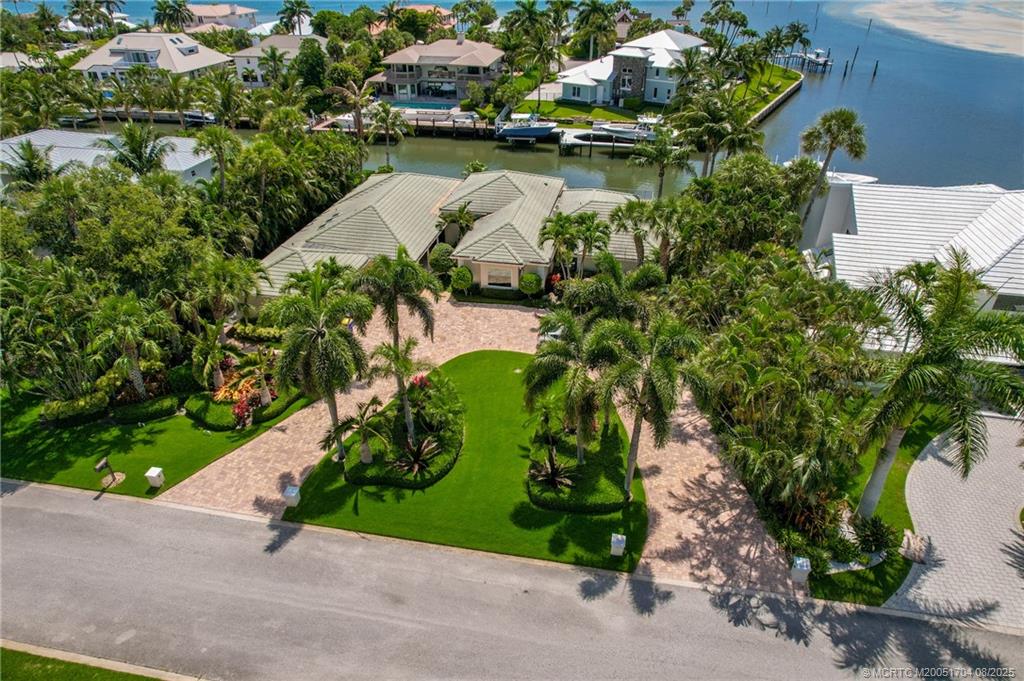 16 East High Point Road Sewall's Point, FL 34996 - Photo 3 of 40 an aerial view of a house a yard and lake view