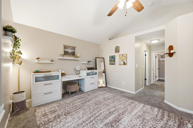 1112 Eagle Ridge Circle Sandy, UT 84094 - Photo 13 of 38 Vaulted ceiling with an overhead fan, plush carpeting, and light neutral wall tones
