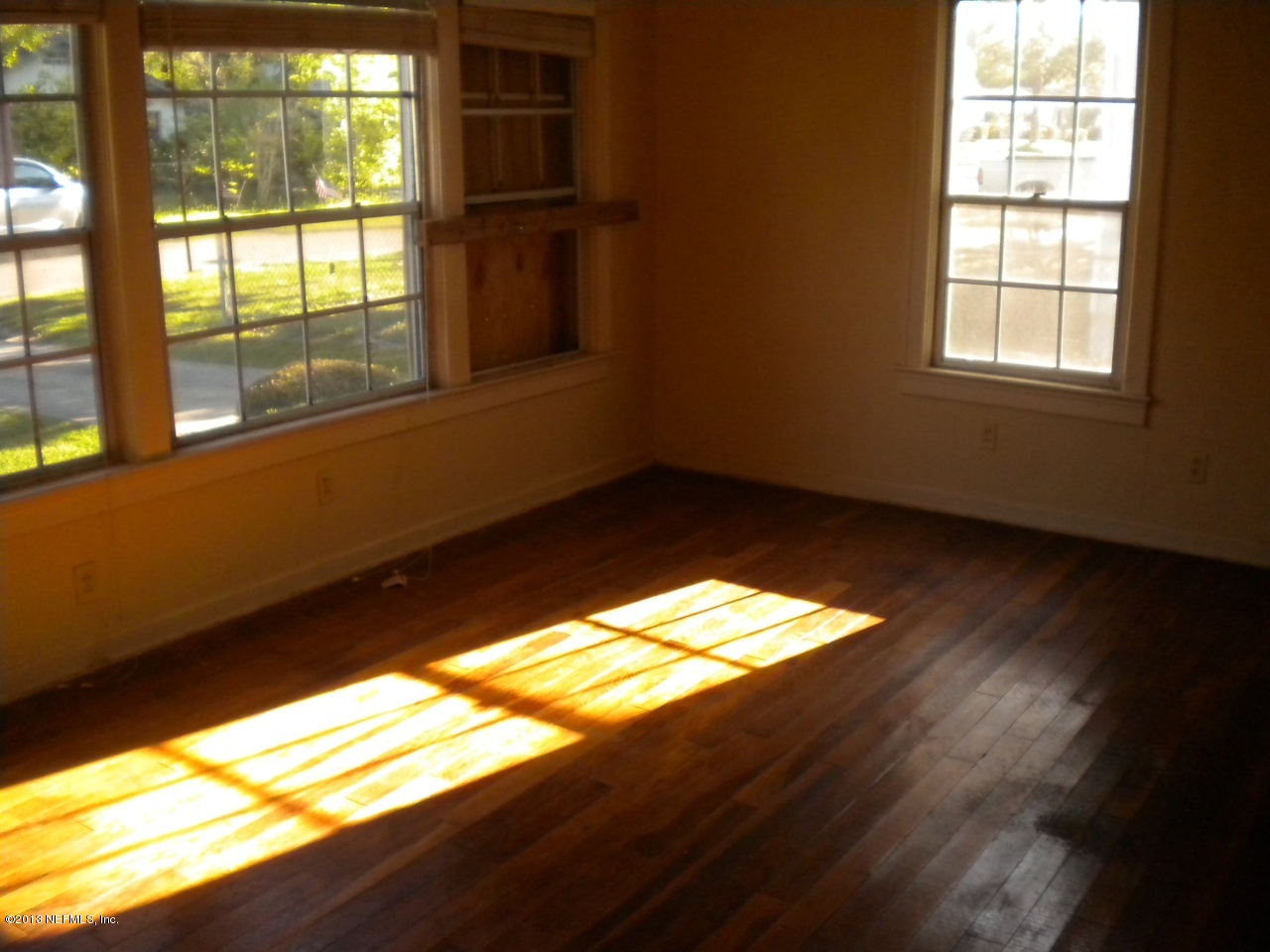 4766 Manchester Road Jacksonville, FL 32210 - Photo 2 of 10 a view of empty room with wooden floor and fan
