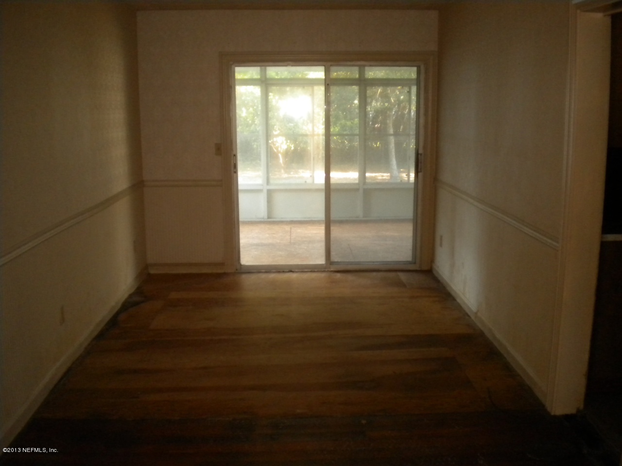 4766 Manchester Road Jacksonville, FL 32210 - Photo 3 of 10 a view of a room with wooden floor and windows