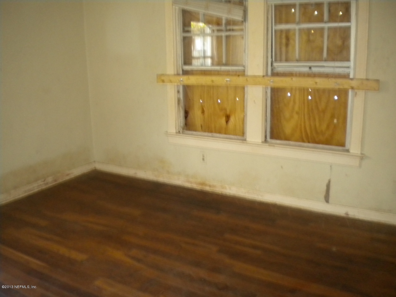 4766 Manchester Road Jacksonville, FL 32210 - Photo 5 of 10 a view of an empty room with wooden floor and a window
