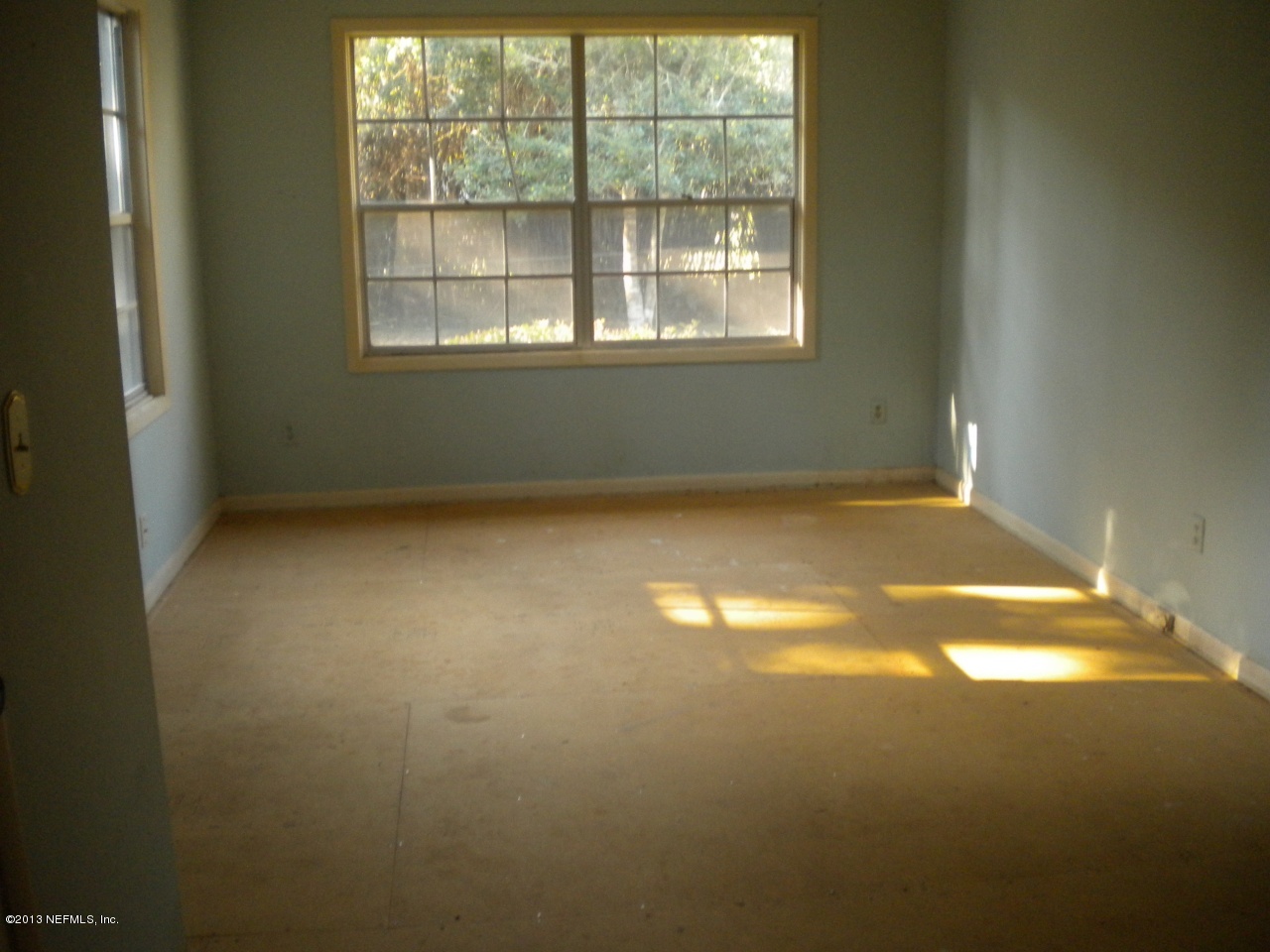 4766 Manchester Road Jacksonville, FL 32210 - Photo 6 of 10 an empty room with a empty space and a window