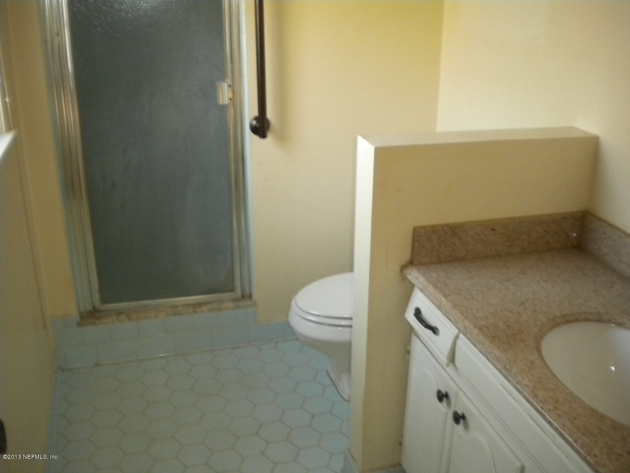4766 Manchester Road Jacksonville, FL 32210 - Photo 7 of 10 a bathroom with a granite countertop sink a toilet and shower