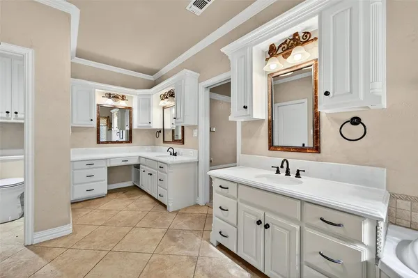 a spacious bathroom with a double vanity sink mirror and