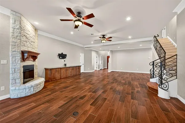 a view of a livingroom with wooden floor and a ceiling fan